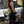 Person with tattoos wearing black WOMENS WEIGHTLIFTING COMPRESSION SINGLET S-3 with visible branding in an indoor setting (Back view) - Warm Body Cold Mind